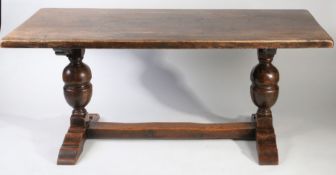 20th century oak refectory dining table, the rectangular top raised on large baluster supports