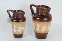 Two Royal Doulton stoneware jugs, each decorated with Egyptian figures, the smaller with a pewter