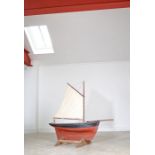 A fine & large early 20th century pond yacht, single sail, painted in black & red, 144cm in