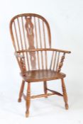 An Elm Windsor chair, with a pierced slat back with turned spindles raised on a elm seat with turned
