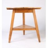 A 19th Century pine cricket table, circular plank top raised on three square tapered legs, with