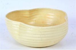 Clarice Cliff pottery bowl, of shaped form with ribbed body, cream glaze, 22cm wide