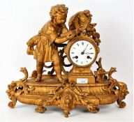 French gilt metal mantle clock, decorated with a young child reading a book, the white dial with