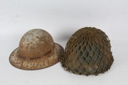 M1 type combat helmet with liner, chin strap, and net helmet cover, together with a WW2 British