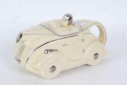 An Art Deco Sadler novelty tea pot in the form of a racing car in cream and chrome, marks to base,