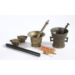 Two brass pestles and mortars, two cased sets of Nuremberg weights, ebony draughtsman's rule, set of