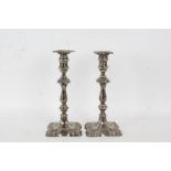A Pair of George III style silver plated candlesticks, with a knopped steam and a shaped base,