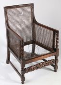 20th century oak bergere style armchair, with barley twist supports, the cane seat AF