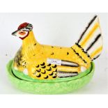 Staffordshire style egg tureen, in the form of a chicken, with naturalistic base, 24cm long