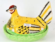 Staffordshire style egg tureen, in the form of a chicken, with naturalistic base, 24cm long