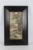 1920's Japanese silk embroidery, depicting trees by a river, housed in a glazed and ebonised