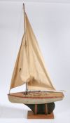 Single masted pond yacht "Girelle", possibly French, the two piece sail above a wooden deck, metal