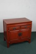 Chinese red lacquered side cupboard, fitted two short drawers over a pair of doors, 77cm wide,