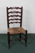 Late 18th/early 19th Century ladder back single chair, the arched ladder back above a rush seat