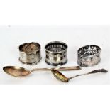 Three various silver serviette rings, a silver sifter spoon and a silver teaspoon (5)