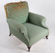 Late Victorian deep seated armchair, in the manner of Howard & Sons, raised on ring turned knopped
