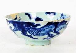 A Chinese porcelain bowl, the bowl decorated with a dragon with a blue glaze, with marks to base,