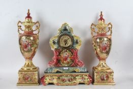 Royal Crown Coronia porcelain mantle clock garniture, decorated with a pink and blue ground set with