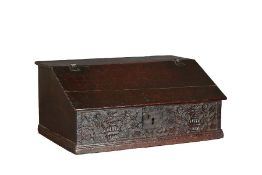 A Charles I oak boarded desk box, Yorkshire, circa 1640 The top and sloping lid with chip-carved