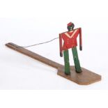 Folk Art: An early 20th century Jigger dancing doll, The figure attached to a wire above the bat,