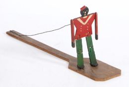 Folk Art: An early 20th century Jigger dancing doll, The figure attached to a wire above the bat,