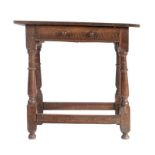 A Charles II oak side table, circa 1680 Having a twin-boarded and end-cleated top, lunette incised-