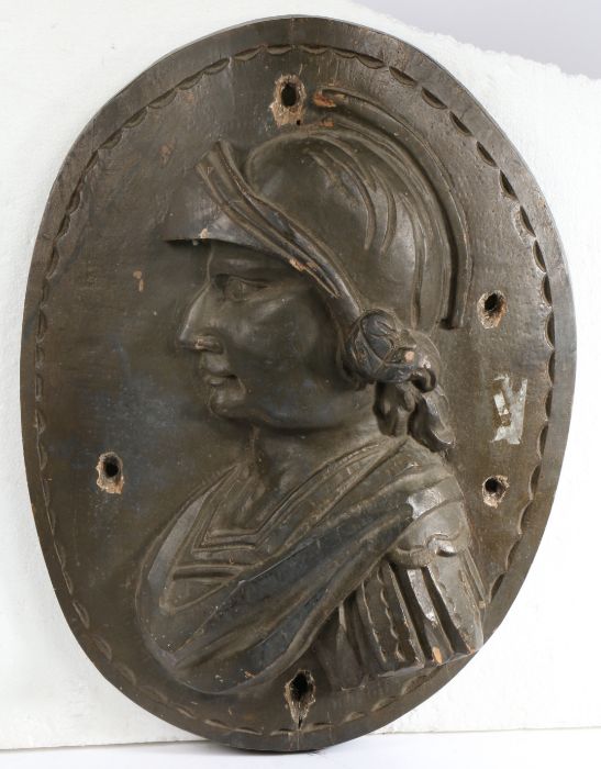 A 17th century carved elm oval panel Designed as a Renaissance solider, 39cm wide, 52cm high - Image 2 of 2