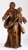 An 18th century walnut figural carving, Madonna and Child The Virgin Mary wearing flowing robes,
