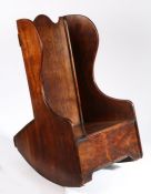 An early 19th century fruitwood child’s rocking wing armchair, Welsh, circa 1820-40 Having an arch-