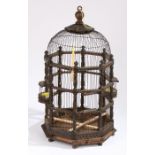 A 19th century bird cage Having an acorn and leaf finial top above a wire frame and acanthus leaf