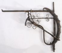 A wrought iron chimney crane, English, circa 1800 Of typical L-shaped form, the upright applied with
