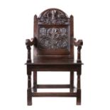 A rare Charles II oak panel-back open armchair, Lancashire, circa 1670 The back panel well-carved