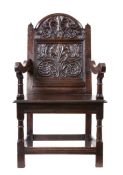A rare Charles II oak panel-back open armchair, Lancashire, circa 1670 The back panel well-carved