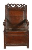 A Charles II oak panel-back and box-seated open armchair, Cheshire, circa 1670 Having a plain