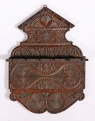 A small 19th century oak chip-carved spoon or pipe rack The backplate with pediment cresting and