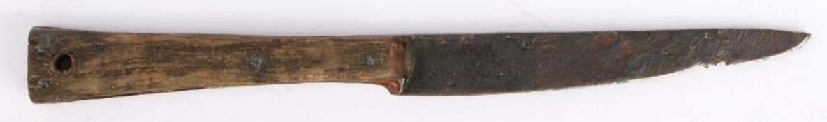 A mid-15th century table knife With a fullered iron blade, and wooden handle with pierced hole, 16cm