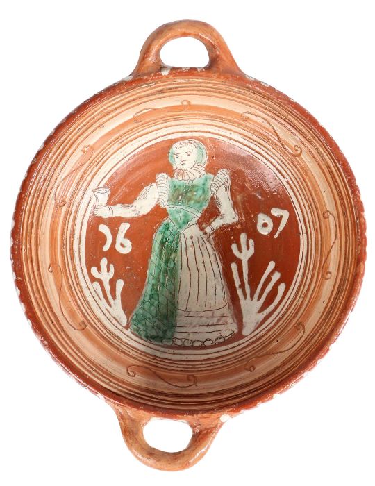 A Dutch slipware twin handled bowl, dated 1607 The centre of the bowl with a standing female