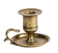 An unusual George III small cast brass chamberstick, circa 1780 Having a large straight-sided candle