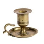 An unusual George III small cast brass chamberstick, circa 1780 Having a large straight-sided candle