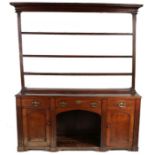 A 19th century oak high ‘dog-kennel’ dresser, English The open rack with deep cavetto-moulded