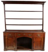 A 19th century oak high ‘dog-kennel’ dresser, English The open rack with deep cavetto-moulded