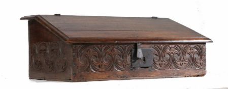 A Charles II oak boarded desk box, circa 1670 The top and slope with ovolo-moulded edge, the top and