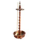 A 19th century treen Church Warden pipe stand With finial top, above a disc of three circular holes,