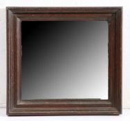 A late 19th century oak framed mirror, English Having a bevelled plate, and deep moulded frame,