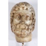 A Roman marble bust, 3rd Century AD With curled hair and beard, eyes looking dexter, later rod to