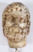 A Roman marble bust, 3rd Century AD With curled hair and beard, eyes looking dexter, later rod to