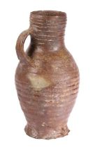 A 16th Century German stoneware  jug, circa 1500 With a ribbed body and loop handle to the bulbous