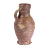 A 16th Century German stoneware  jug, circa 1500 With a ribbed body and loop handle to the bulbous