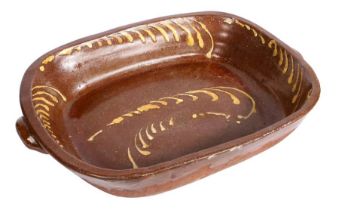 A very large 19th century slipware roasting dish Of rectangular form with a pair of handles, the