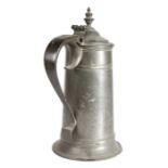 A George I pewter spire flagon, circa 1715 The straight-sided tapering drum with a high fillet,